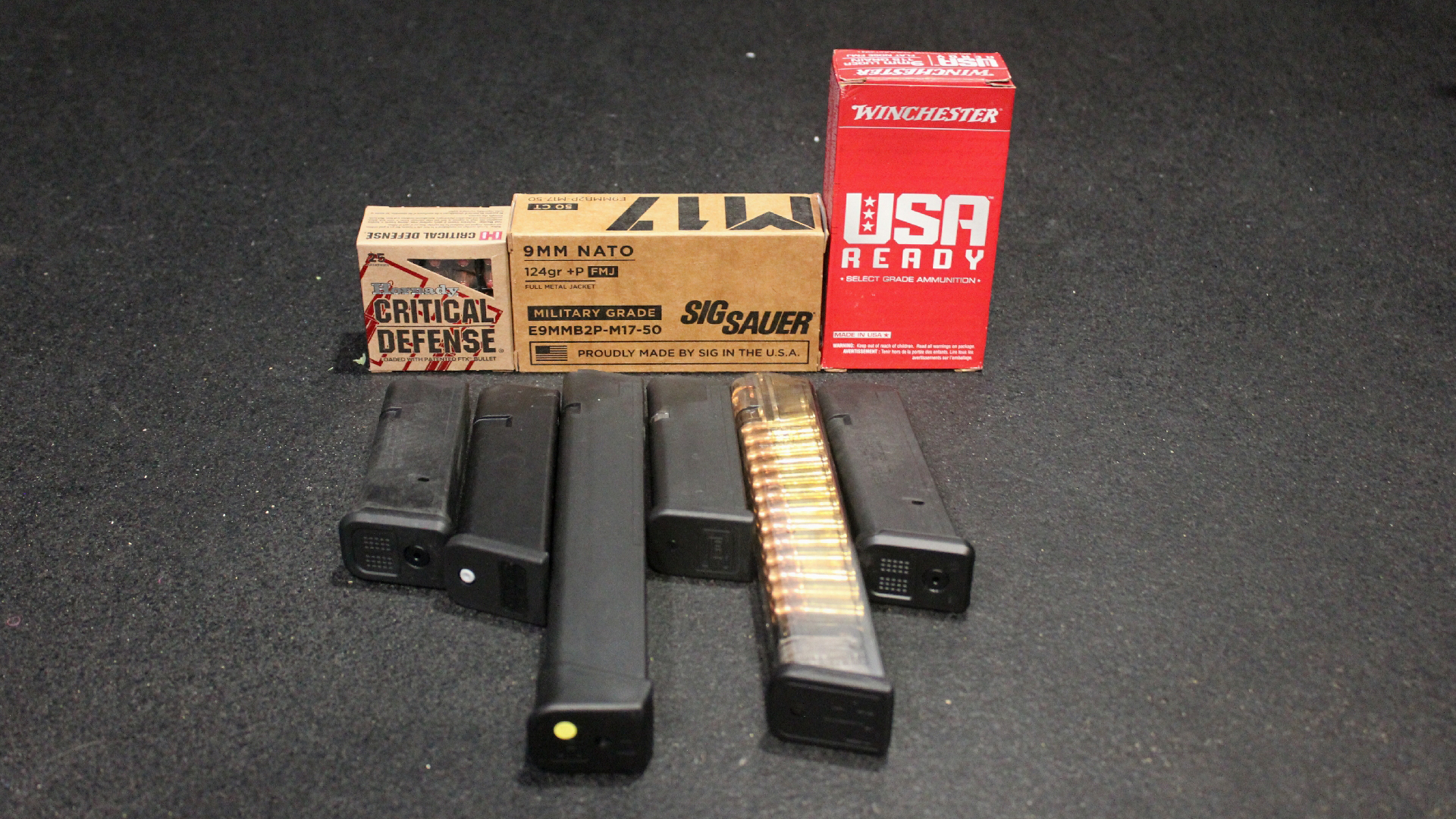 Ammunition boxes shown with random pistol magazines