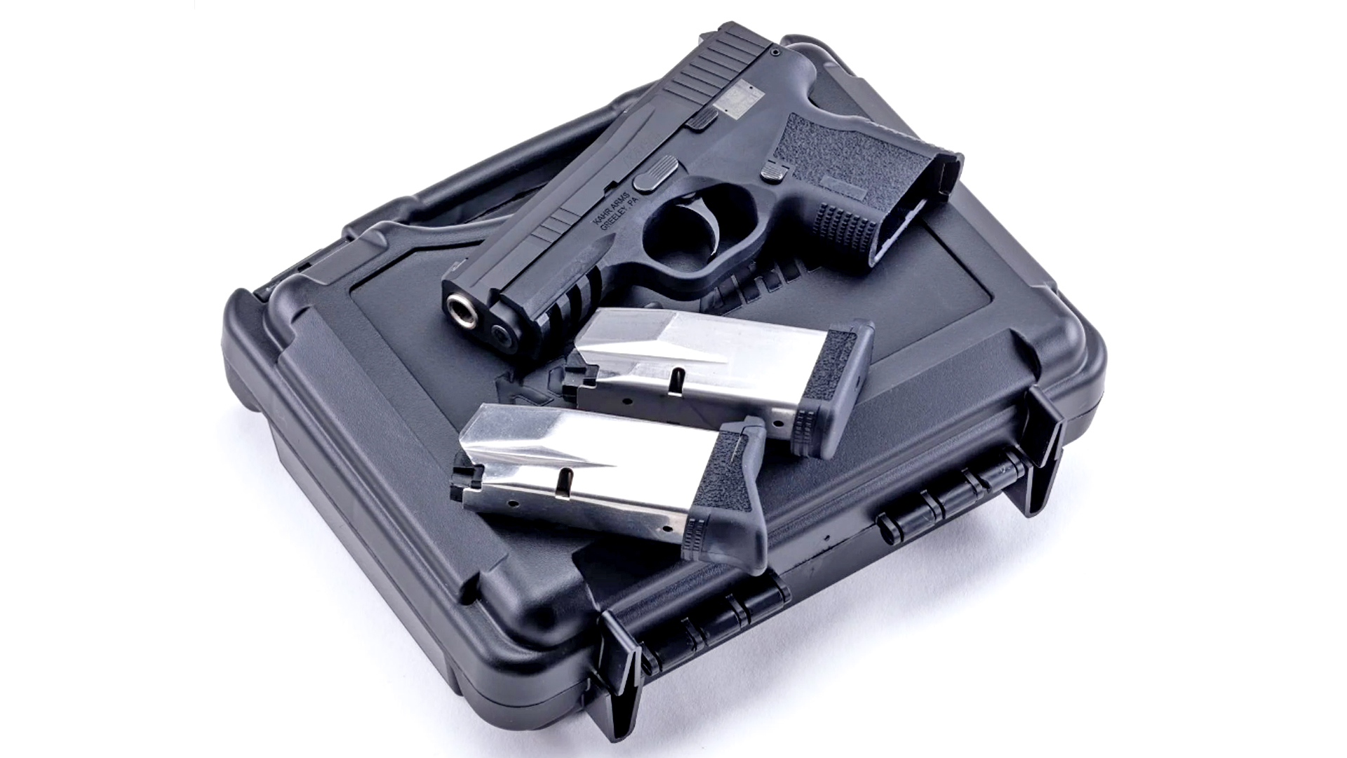 Kahr Arms X9 with two empty magazines, resting on a black, plastic case.