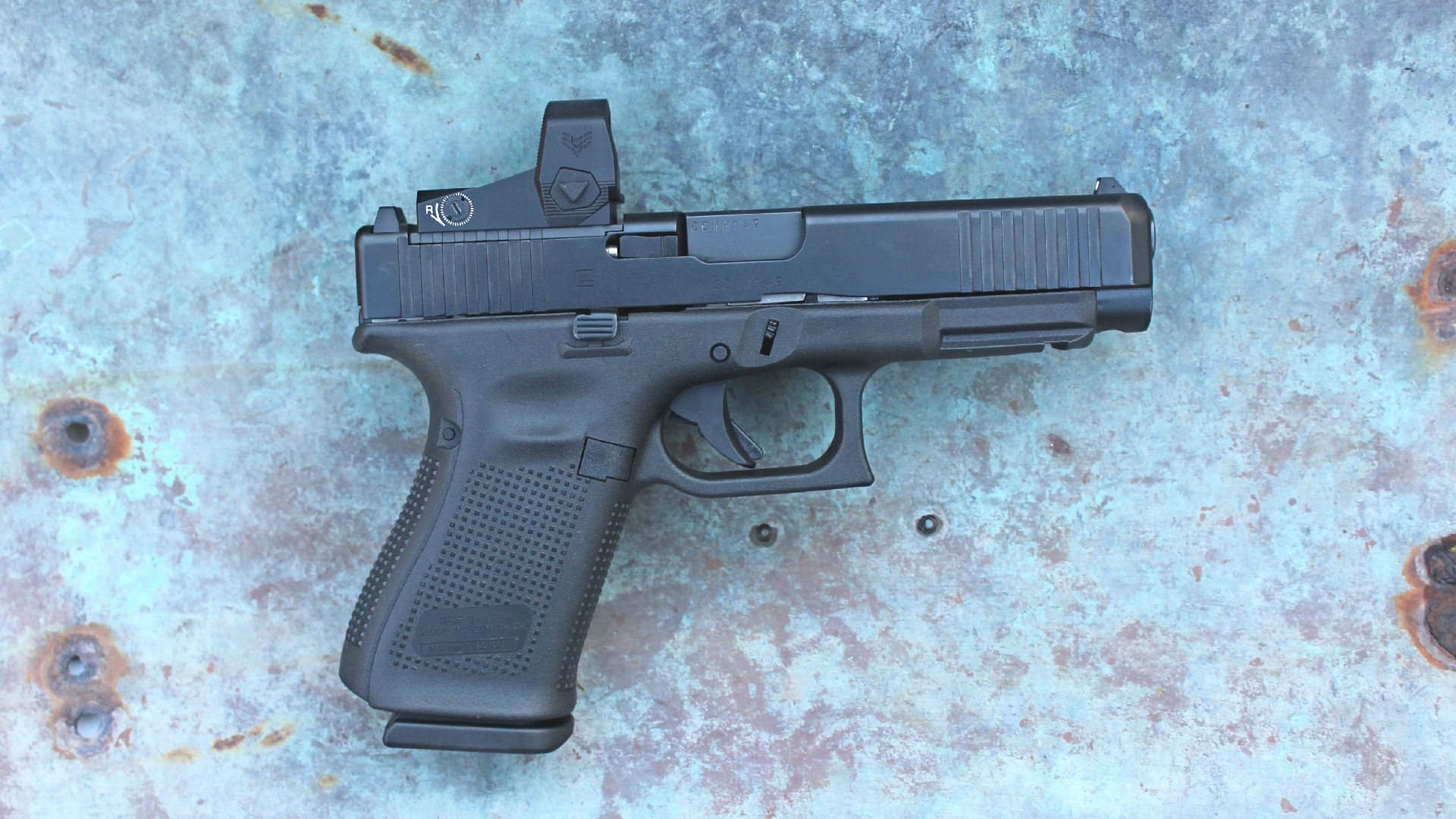 Glock G49 Gen5 MOS right-side view full length black pistol 9 mm luger shown with Swampfox optic attached to gun