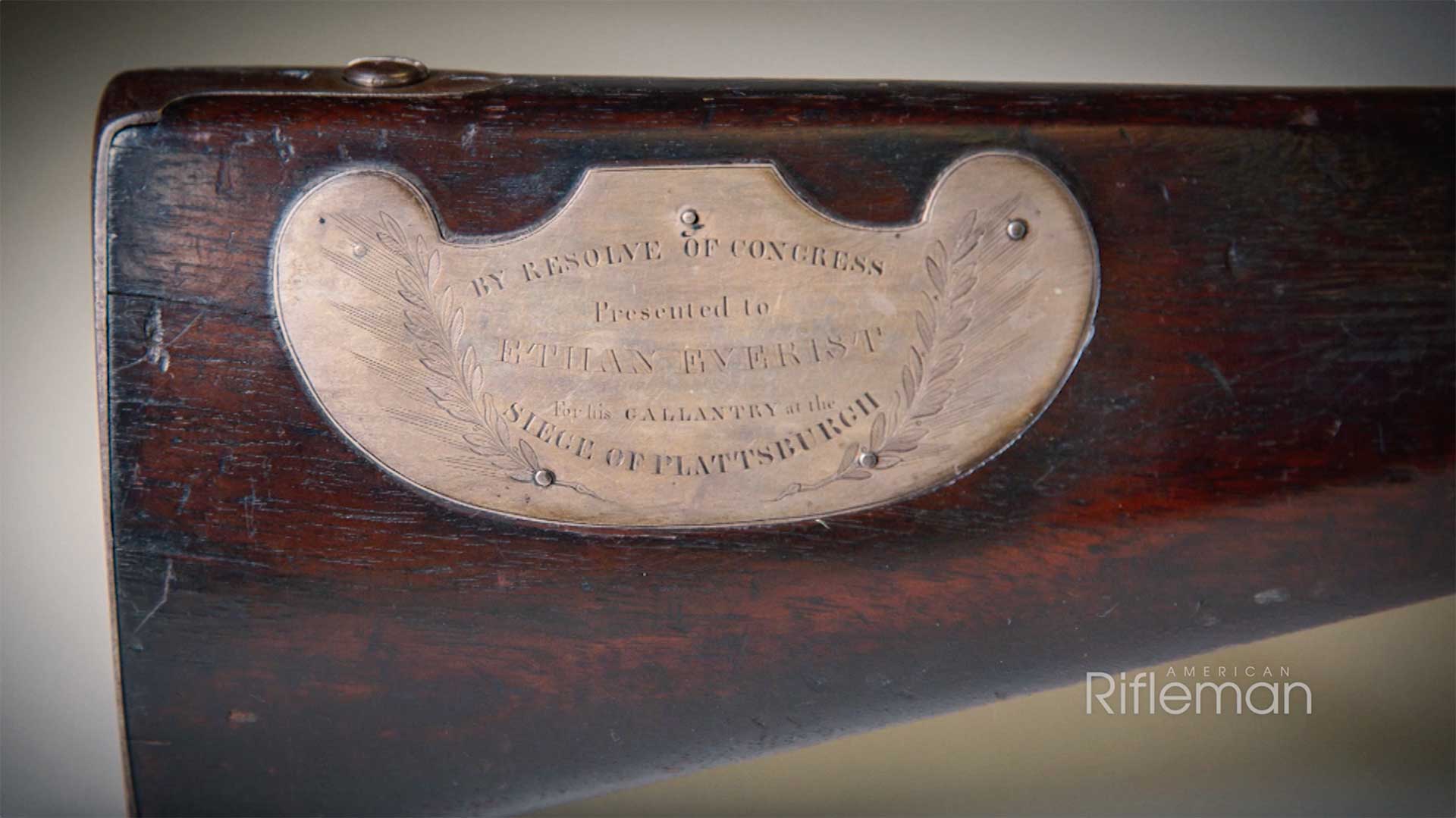 A brass plaque inscription on the butt of a Hall rifle.