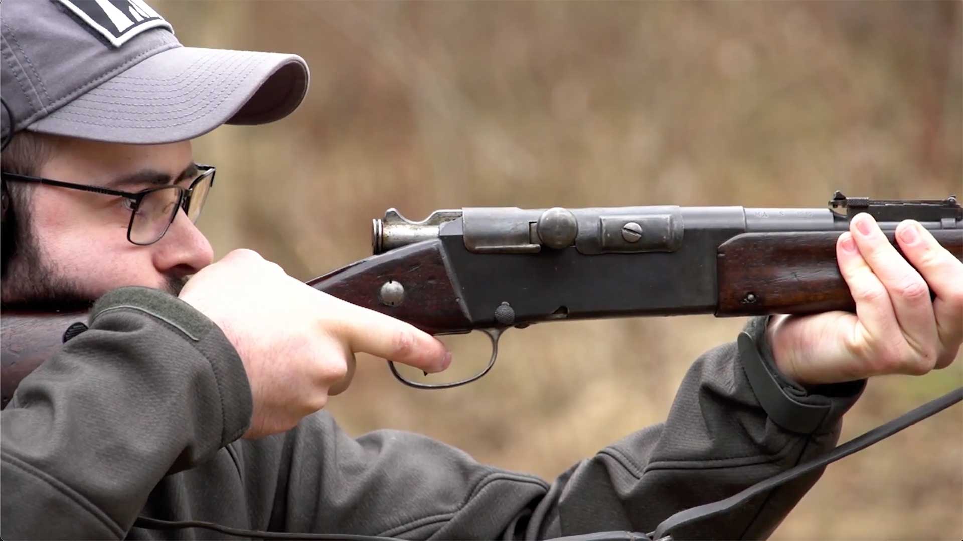 Man aiming a Model 1886 Lebel rifle on an outdoor range.