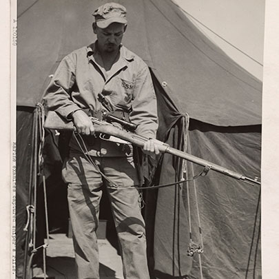 Red sniper: A Marine examines a M1891/30 sniper rifle (with a 3.5X PU scope) in Korea, 1952.