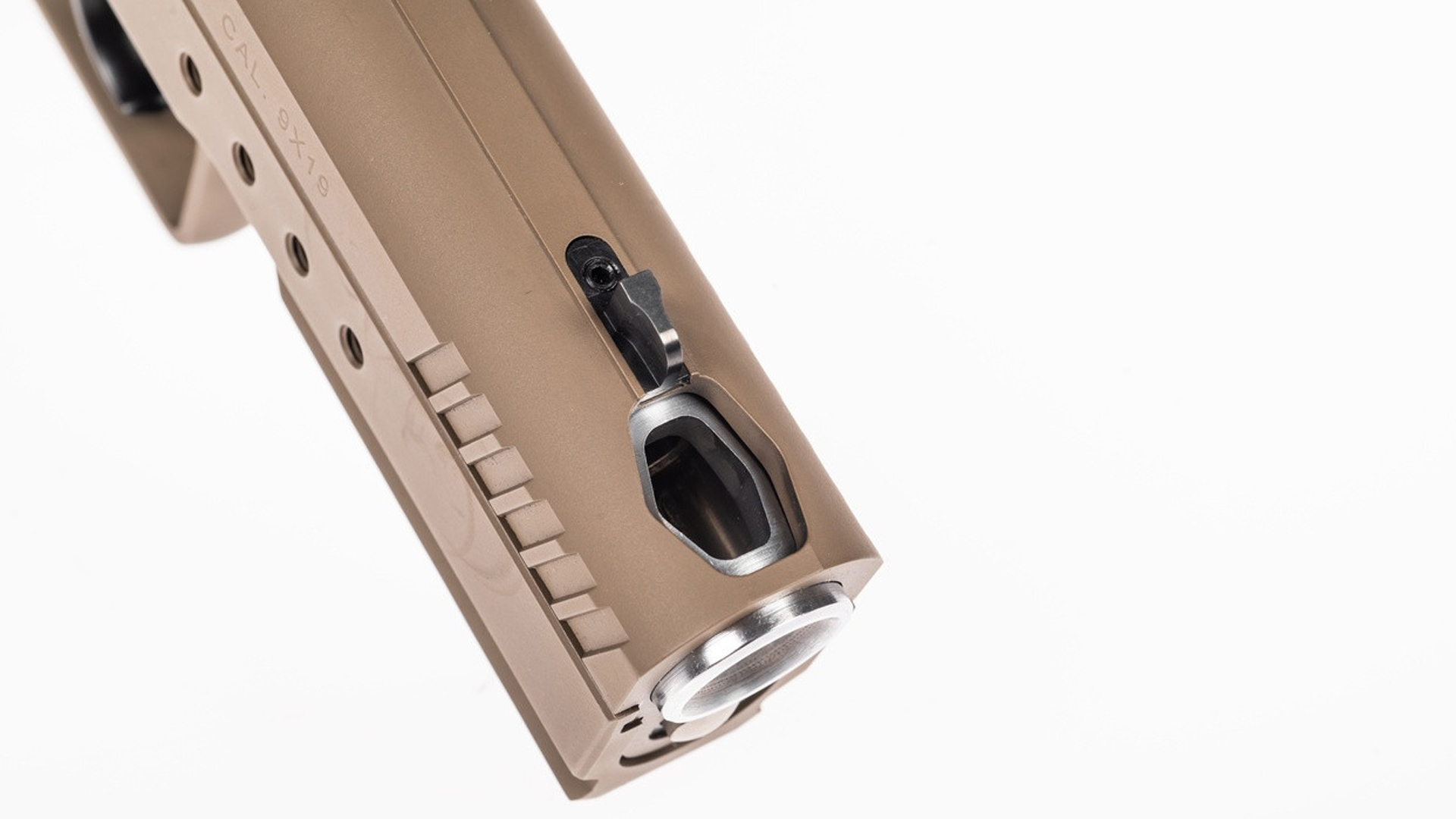 Compensated barrel on a tan Tanfoglio Hexagon pistol.