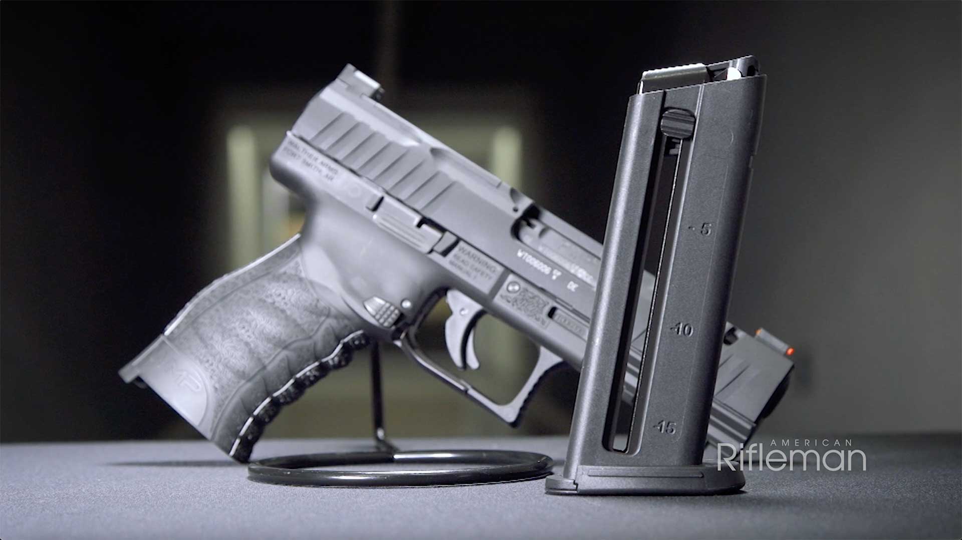 The Walther WMP's magazine standing on a table, with the WMP pistol in the background.