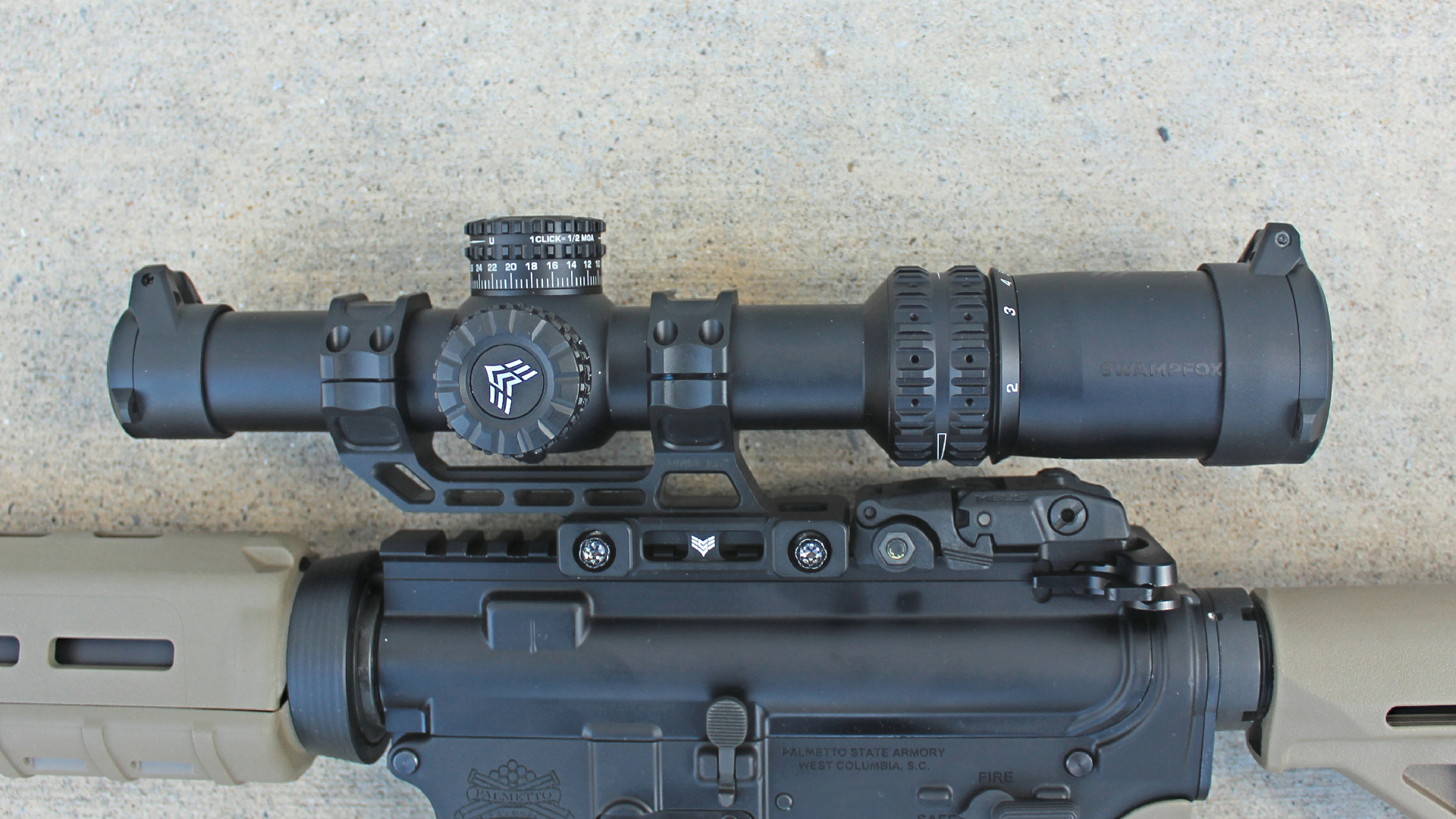 Swampfox Arrowhead riflescope attached to carbine receiver PSA PA-15 left-side view shown on concrete floor