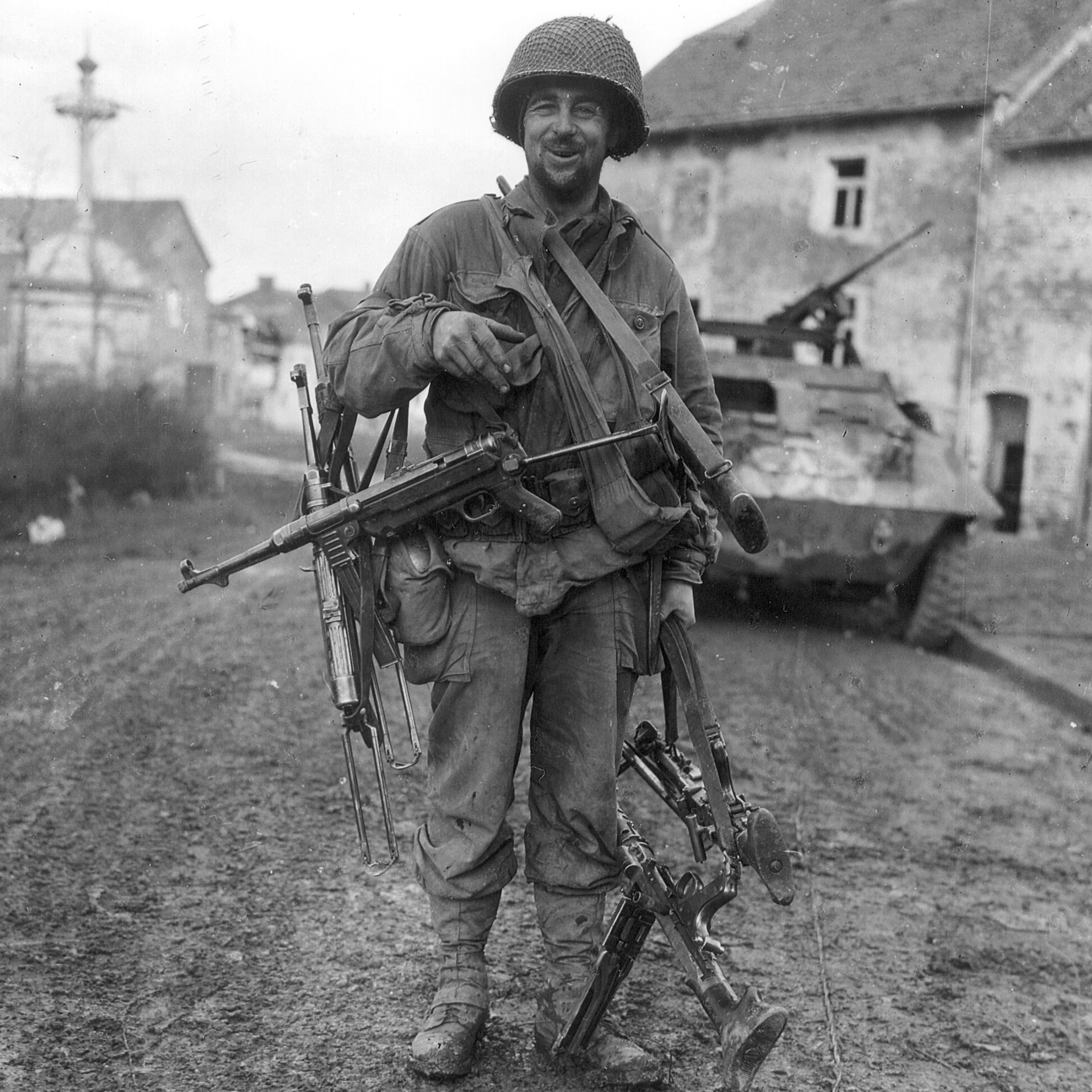 A small fortune in small arms:  This GI in Germany 1945 has a collection that includes a MP38, MP40, MG34, and a MG42 in addition to his standard issue M1 rifle.