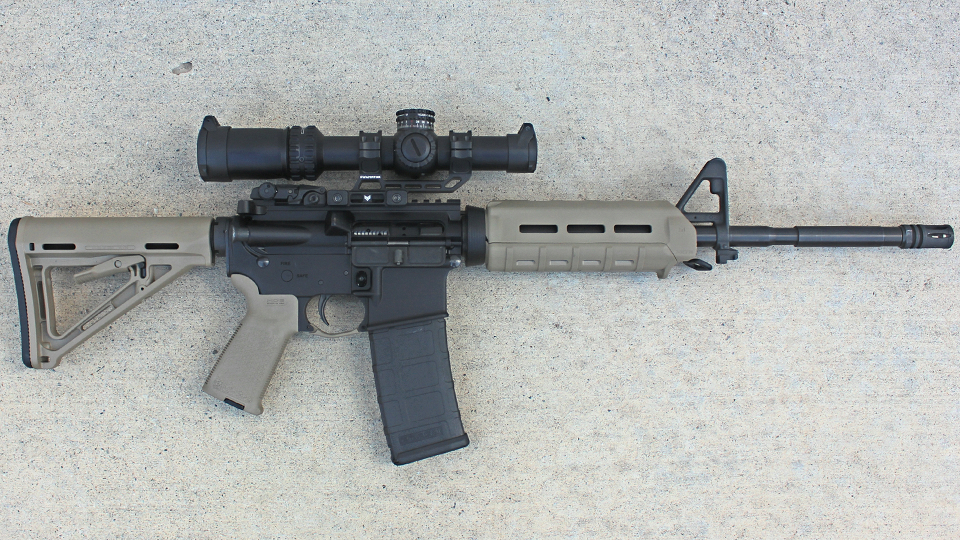 Palmetto State Armory PA-15 carbine right-side view with FDE MOE magpul accessories shown on concrete floor with riflescope attached