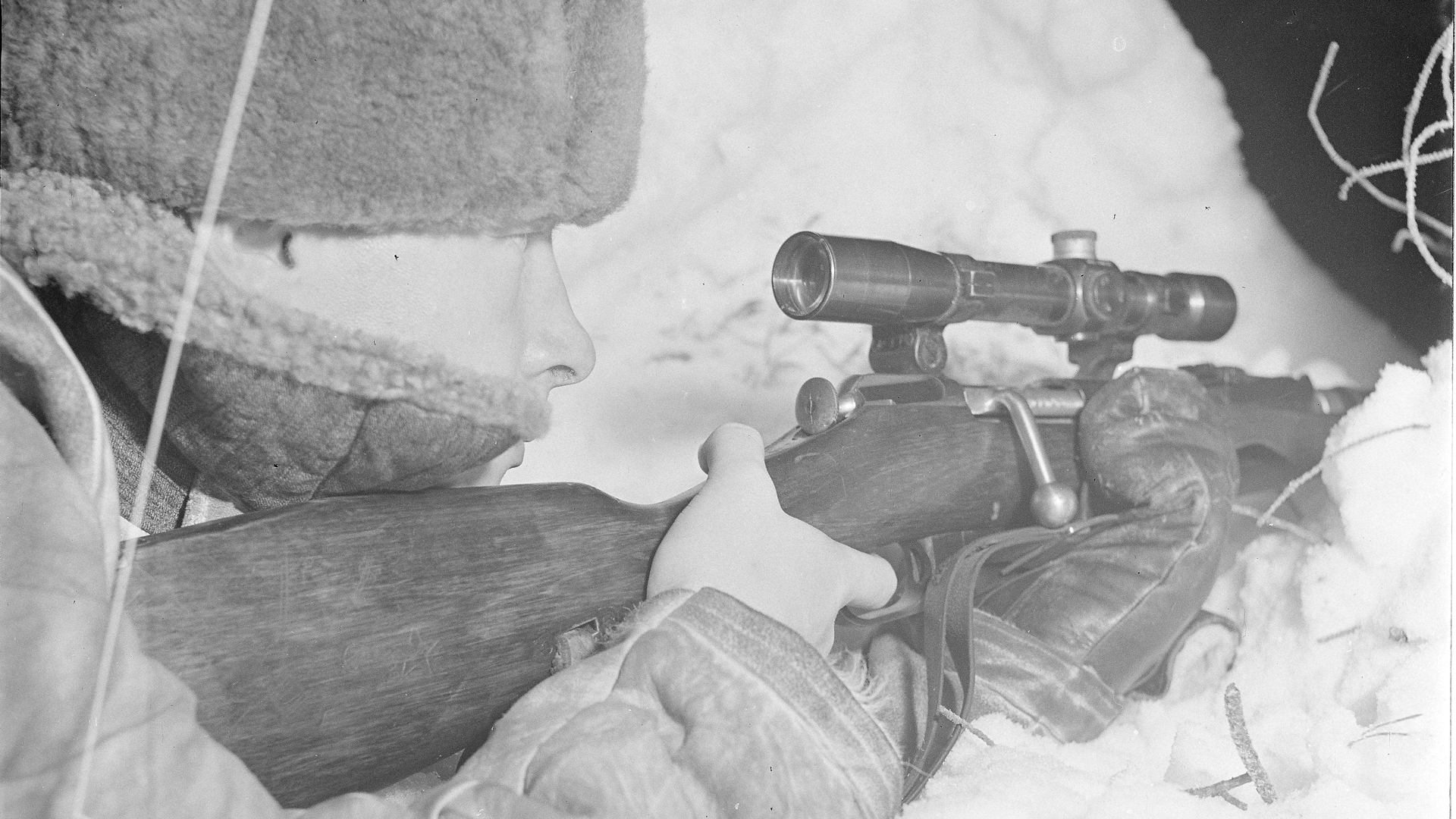 Cold trigger finger:  A Finnish sniper using a captured Soviet M/91-30 sniper rifle (with PE scope).  Note the gloved hand supporting the rifle, but a bare hand on the trigger.  Photo courtesy of Finnish Wartime Photographic Archive, SA-kuva.