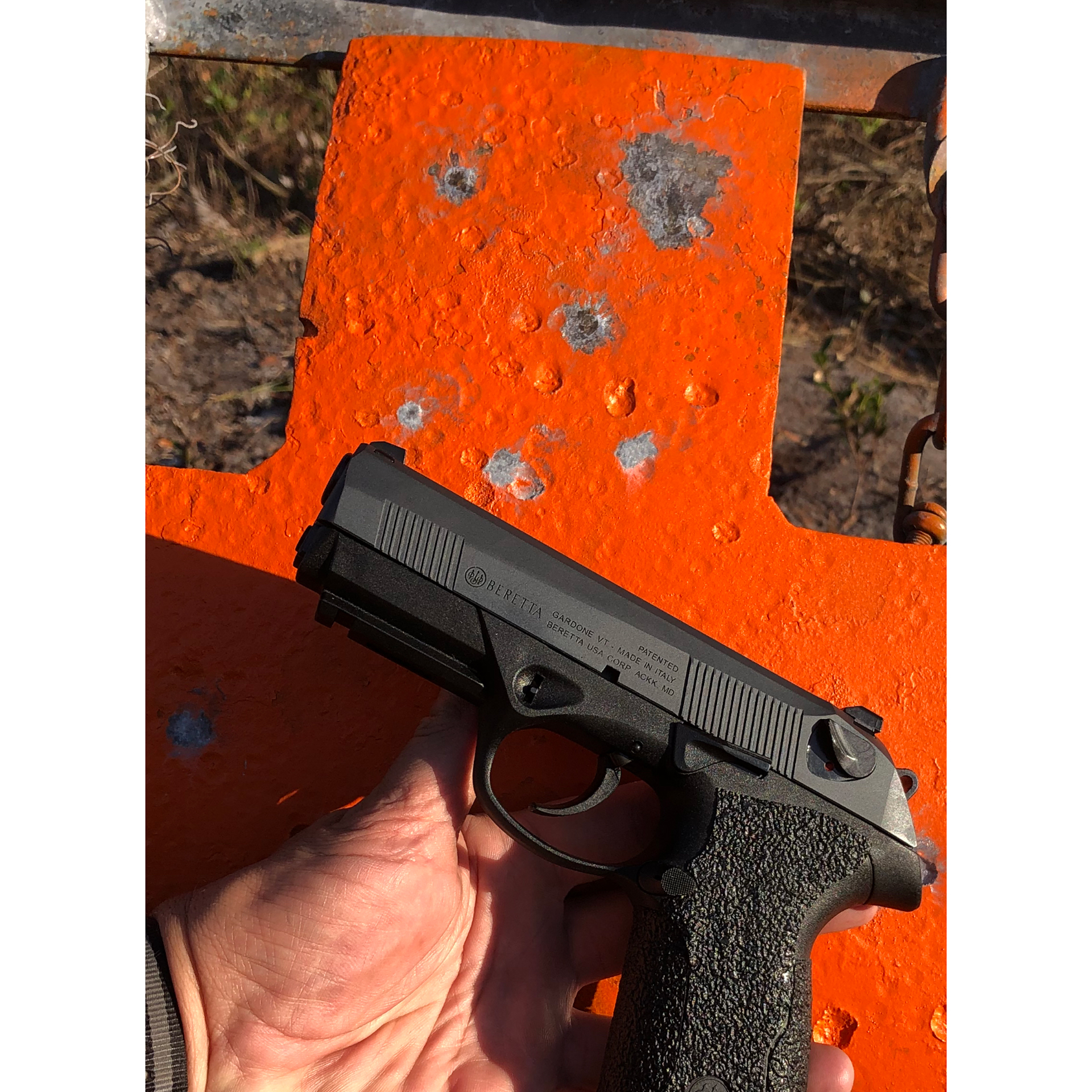 Review: Beretta PX4 G-SD pistol in hand target smile face bullets red target outdoors