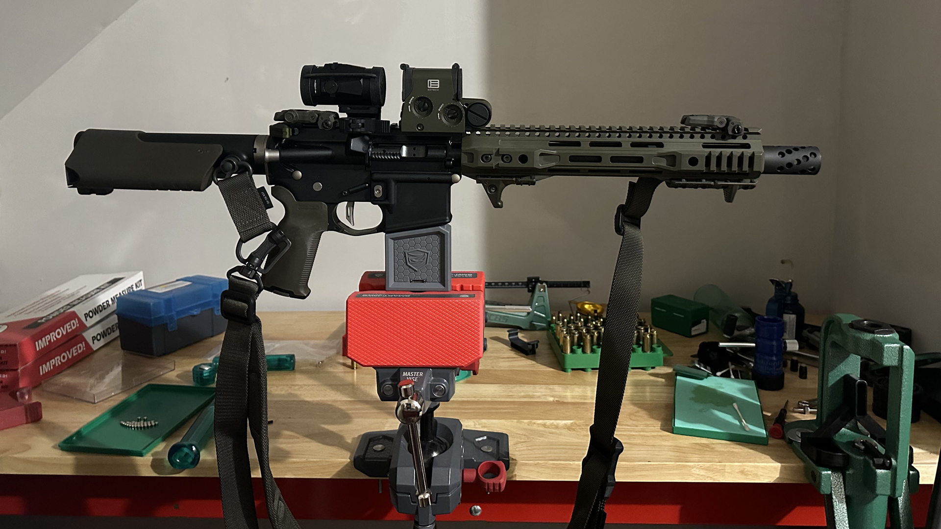 The author's custom ar-15 in vice workbench parts tools accessories