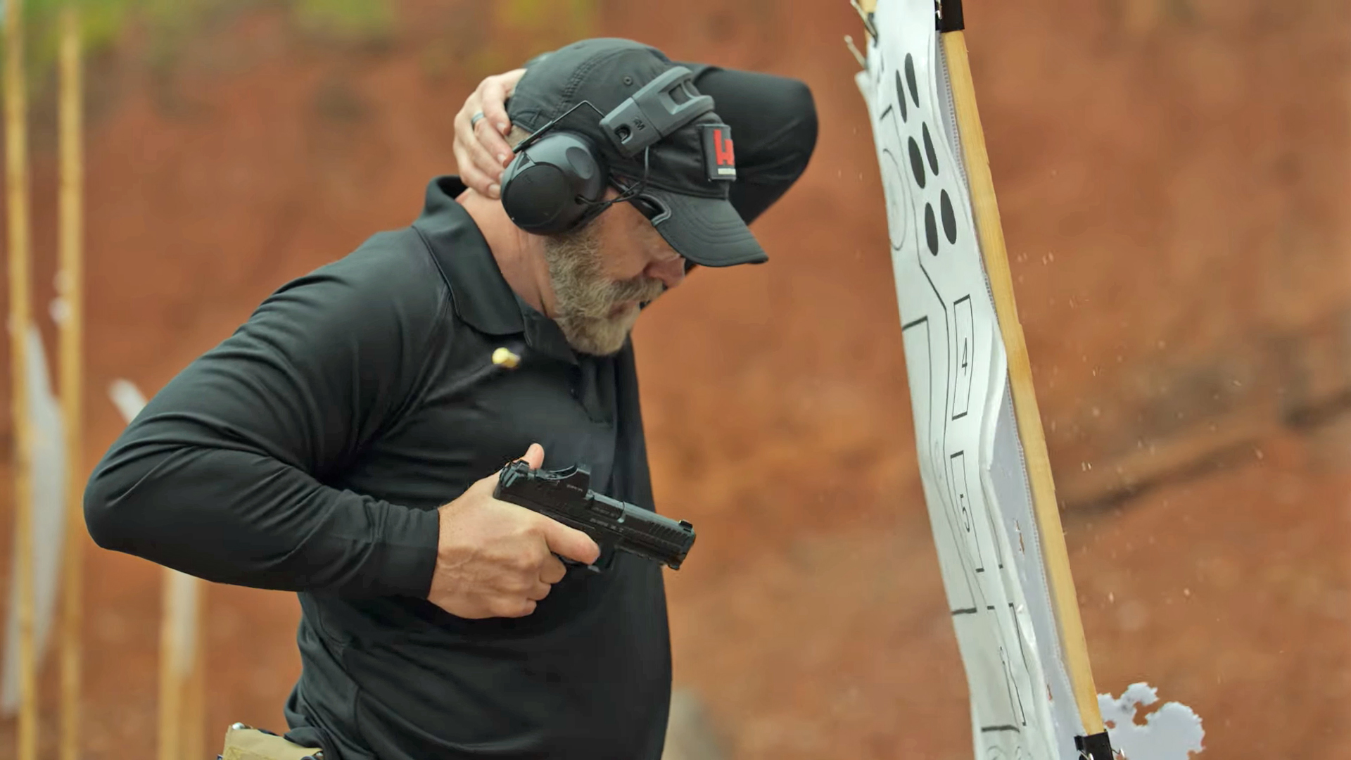 Man shown firing a Heckler & Koch VP9A1 into a paper target.