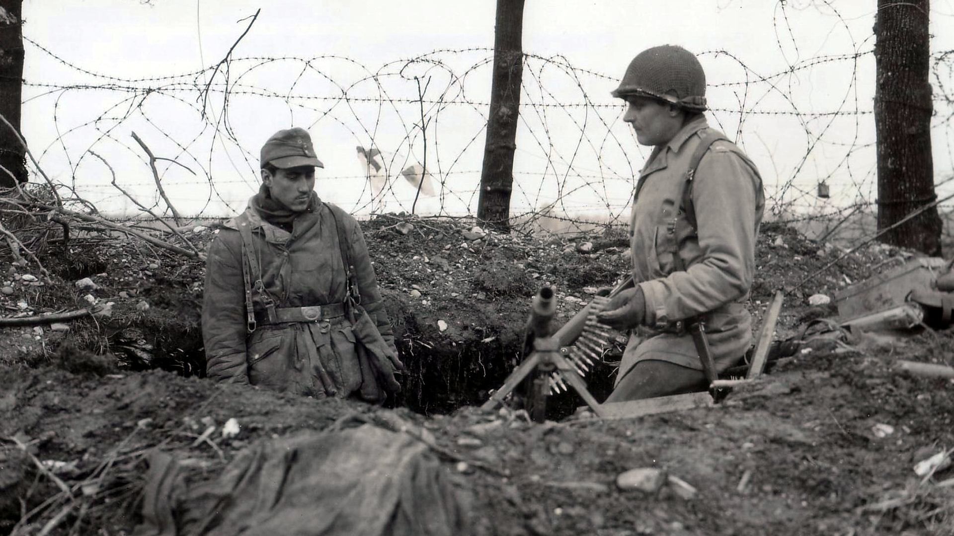 Shades of “Saving Private Ryan”: A GI questions a German about a recently captured MG42. Photo courtesy of National Archives and Records Administration, NARA.