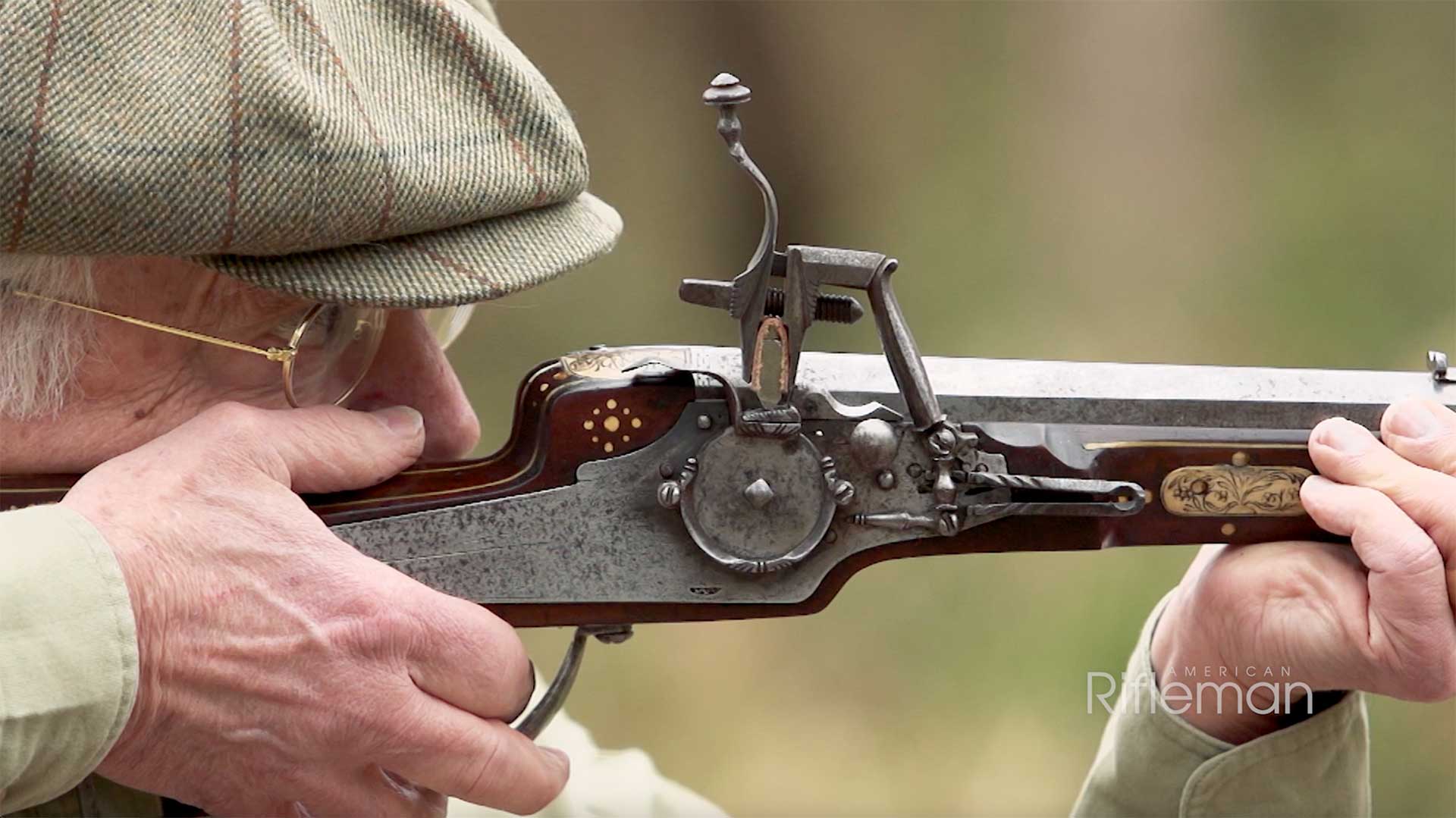 Man aiming a loaded and primed wheellock sporting carbine.