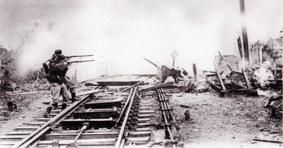 soldiers aimed with mauser rifles across rail tracks destruction background