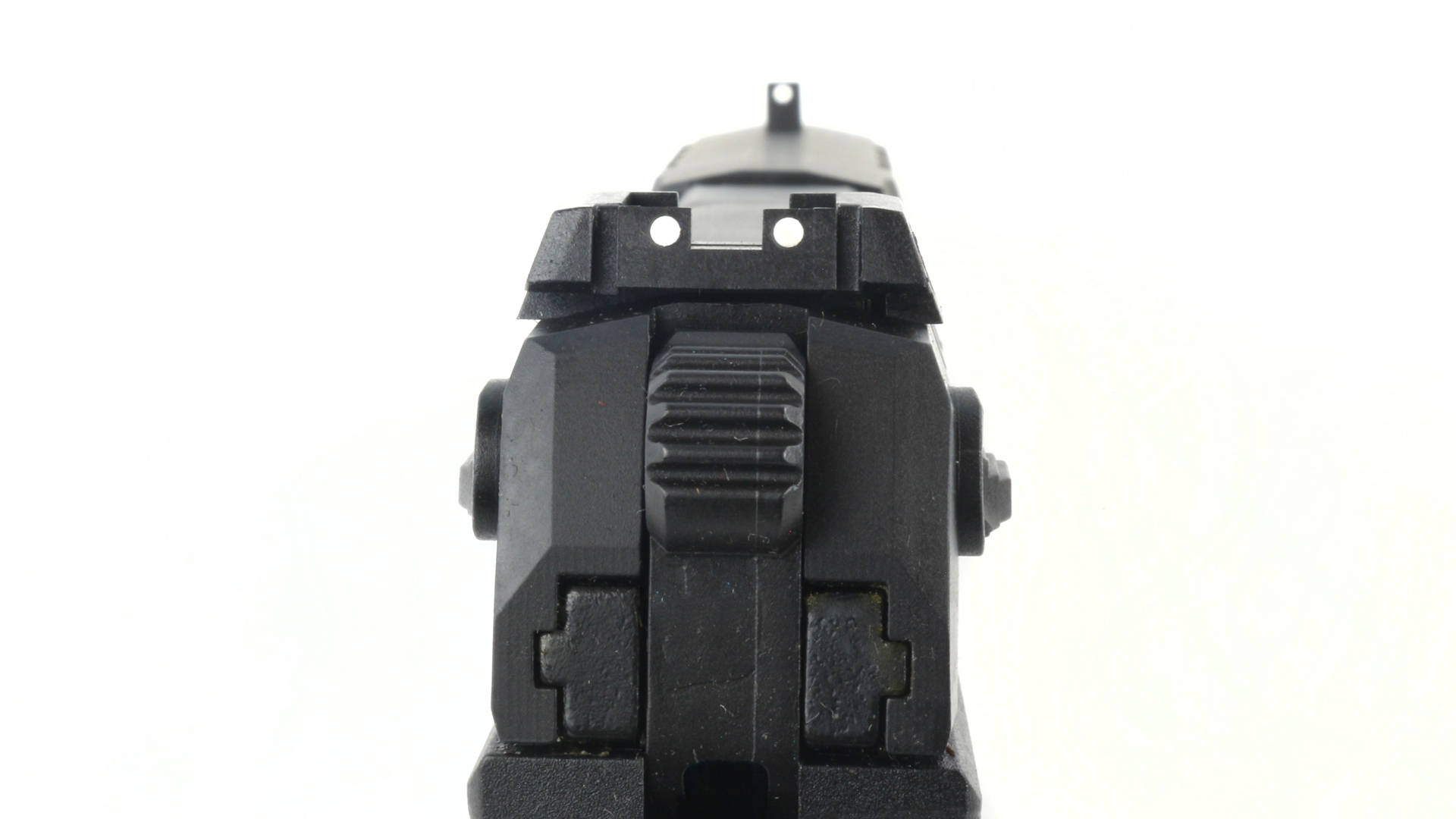 Walther PD380 rear sight in focus front white dot sight blur illustrating rear view of gun