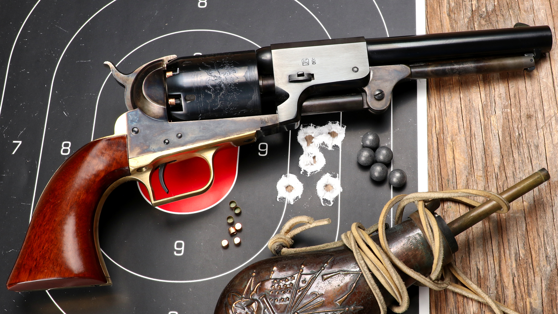 Cimarron Colt 1st model dragoon revolver shown with accessories and target on table