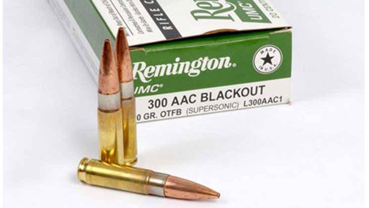 Three .300 Blackout cartridges in front of a Remington ammunition box.
