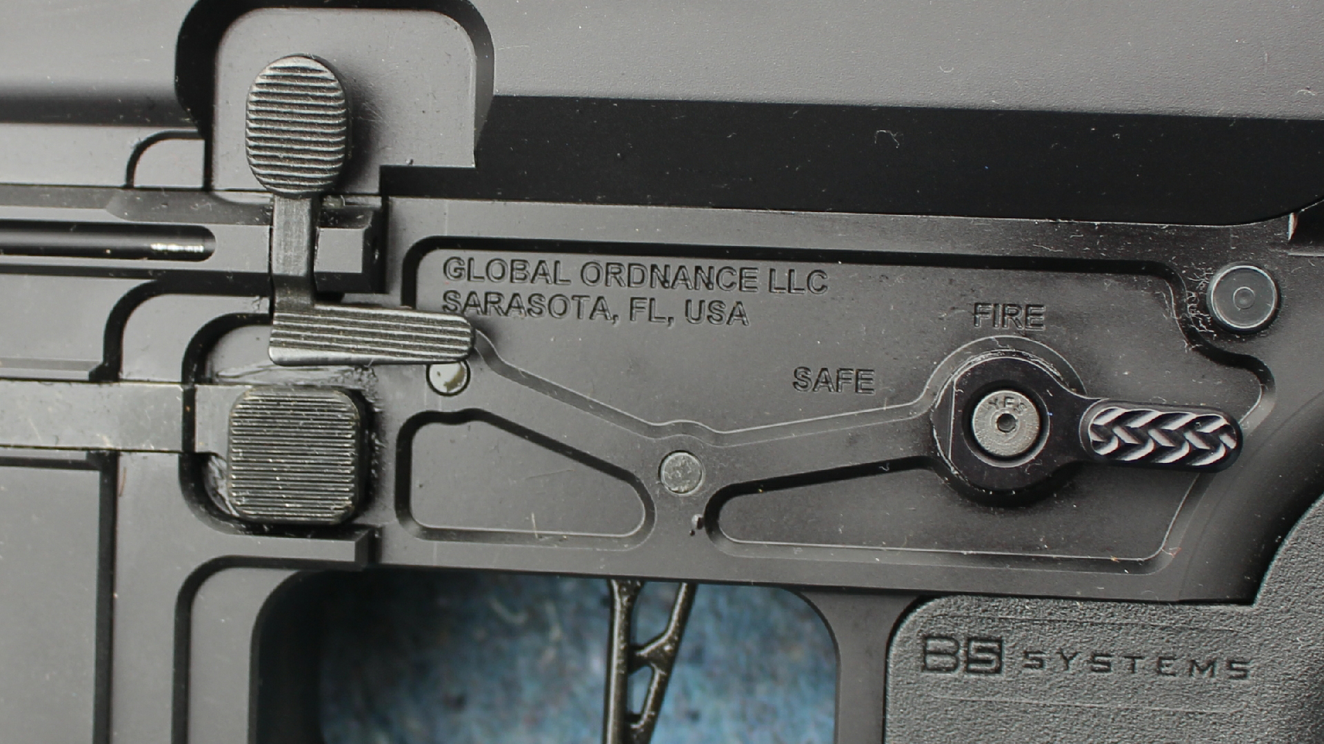 Review: Global Ordnance Monolith Bufferless receiver left-side closeup of controls safety lever magazine release shown with flat-face trigger and b5 systems pistol grip