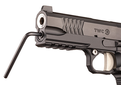 Jacob Grey TWC 9 black pistol slide dustcover muzzle shown with hex wrench inserted into bushingless assembly for disassembly