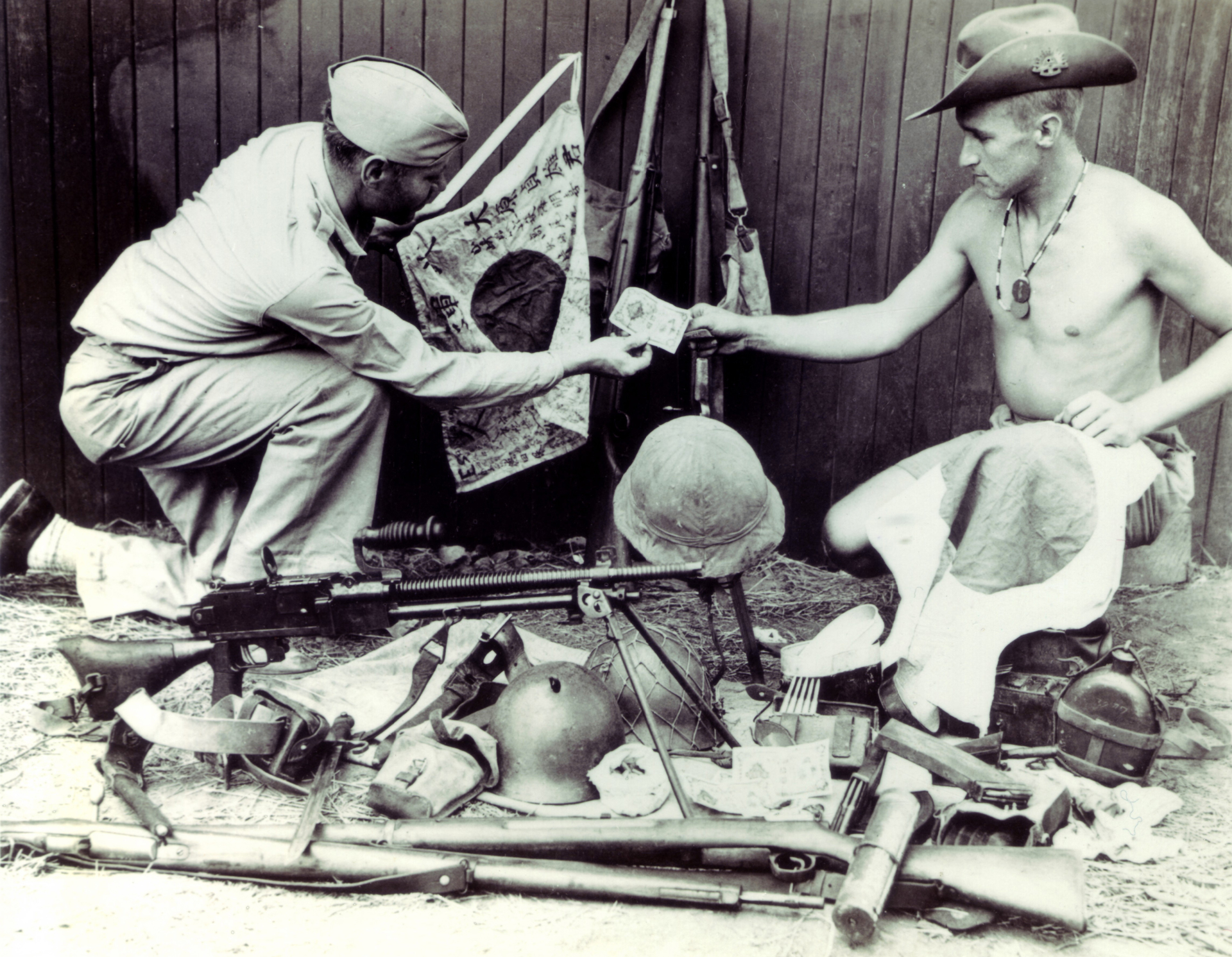 Inter-Allied souvenir sales:  An Australian “dealer” offers trophies for sale, including a Type 96 light machine gun.