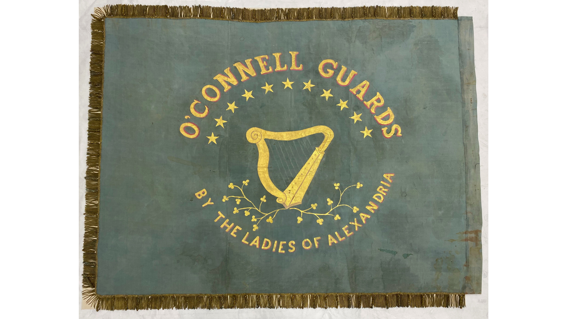 Public appeals went out in the Alexandria Gazette for the ladies of Alexandria to make uniforms for the O’Connell Guards in the week before the invasion, and, apparently, some uniforms were produced.  This hand-embroidered flag was later smuggled out of Alexandria and presented to the O’Connell Guards in June 1861 when they were in Manassas.  Courtesy, Heritage Conservation, LLC