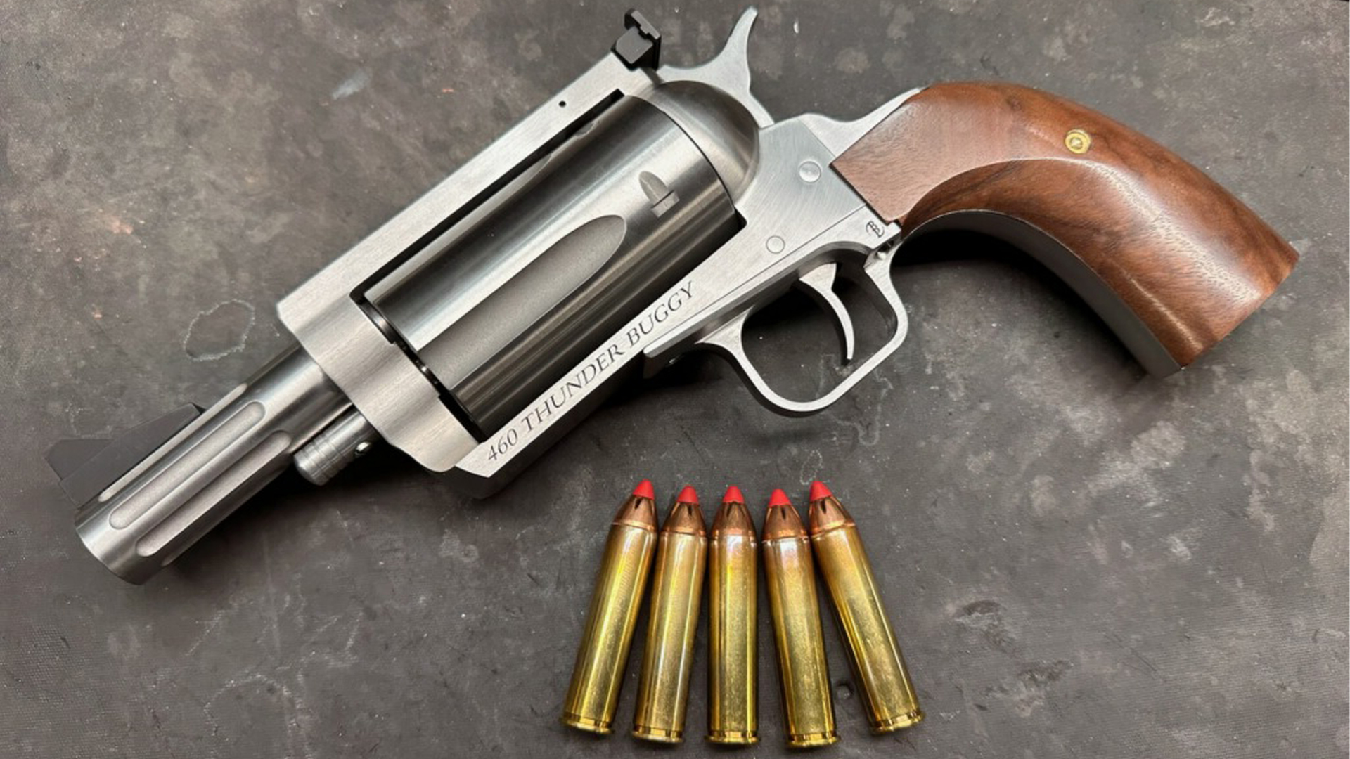 Magnum Research Thunder Buggy BFR left-side view shown with brass cartridges revolver gun wood stocks