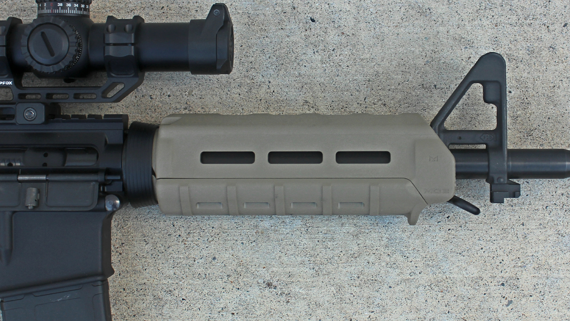 Palmetto State Armory PA-15 carbine right-side view closeup Magpul FDE MOE handguard A2 sight shown on concrete floor