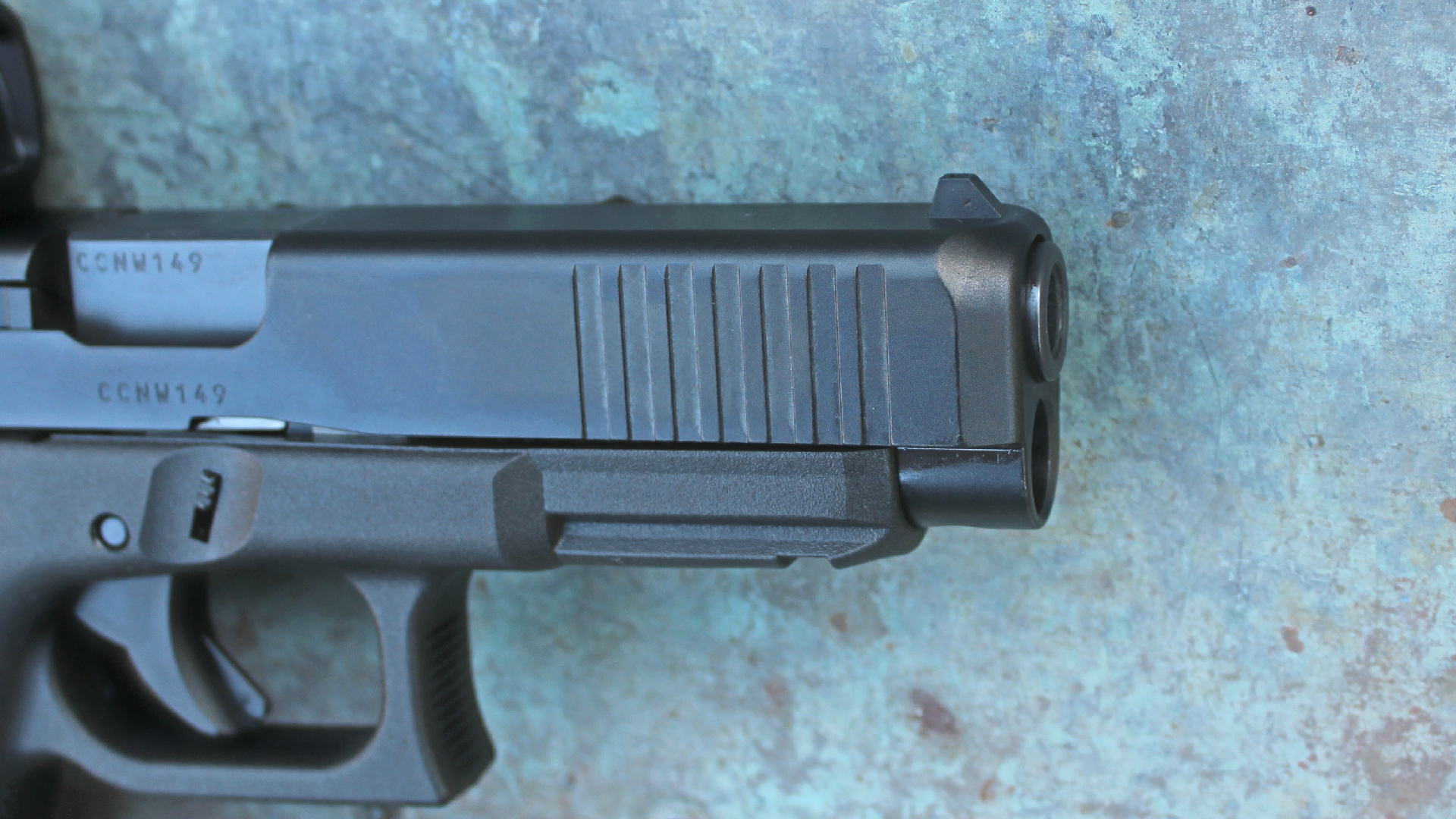 Glock G49 Gen5 MOS closeup pistol barrel slide frame cocking serrations beveled muzzle