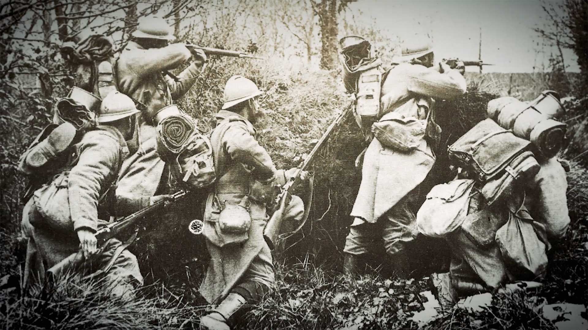 Historical image of French soldiers in a field, armed with the Model 1886 Lebel rifle.