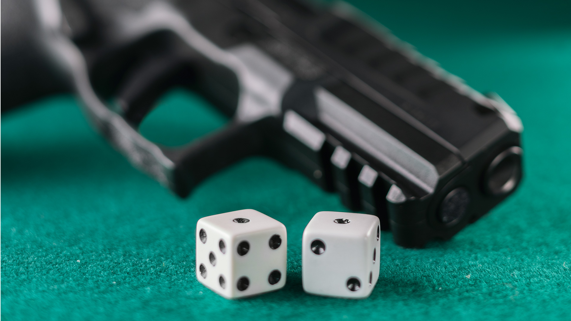 pistol with snake eyes dice