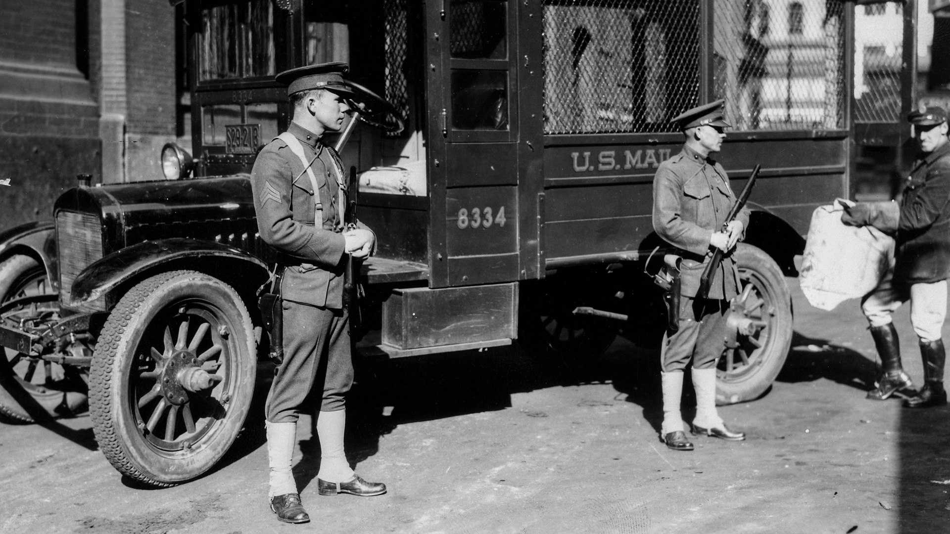 Marines are wearing Model 1911 pistols and carrying Winchester 12-ga. “trench guns.”